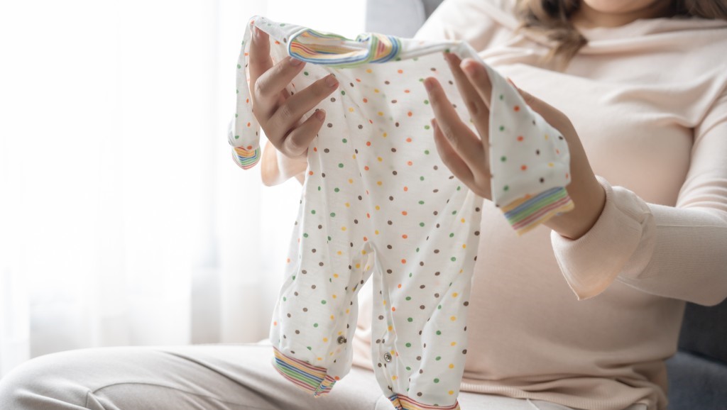 A mom checking new baby clothes