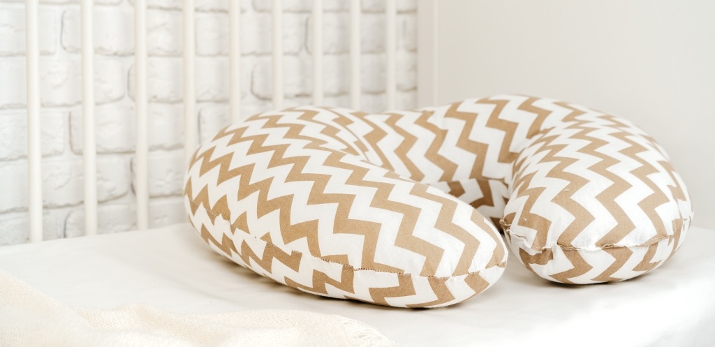 Nursing breast feeding pillow on a bed